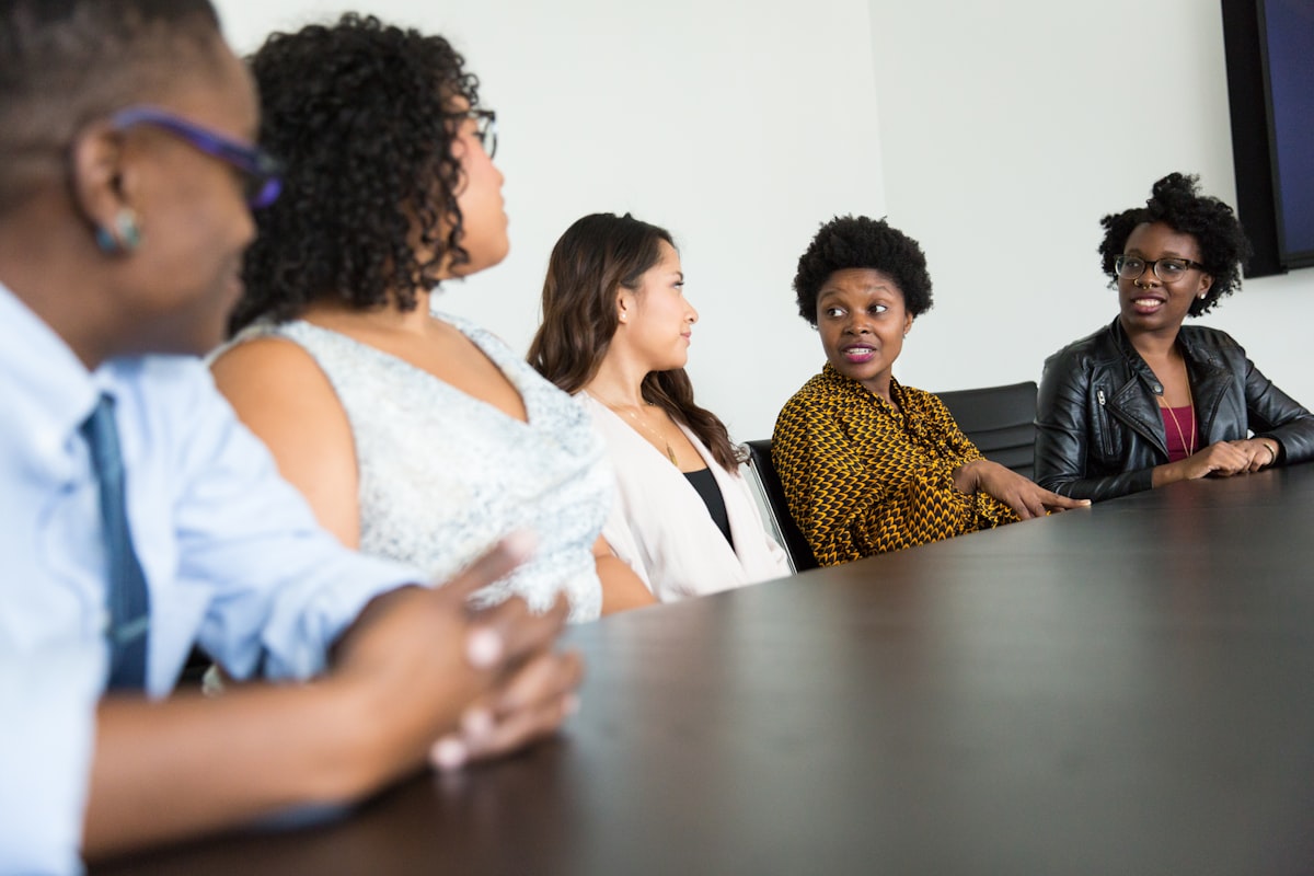 A diverse group of professionals in discussion around a table